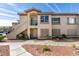 Attractive condo featuring tan stucco, dual entrances, and well maintained landscaping at 5710 E Tropicana Ave # 2218, Las Vegas, NV 89122