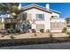 A condo building showcasing its beige stucco exterior and manicured front yard landscape at 5710 E Tropicana Ave # 2218, Las Vegas, NV 89122