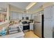 Well-maintained kitchen features stainless steel appliances, light gray cabinets, and functional layout at 5710 E Tropicana Ave # 2218, Las Vegas, NV 89122