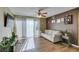 Living room with wood floors, neutral sofa, and sliding glass doors providing natural light at 5710 E Tropicana Ave # 2218, Las Vegas, NV 89122