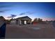 Backyard with covered patio on a lot ready for landscaping at twilight at 60 Pecos St, Las Vegas, NV 89110
