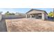 Large backyard featuring a covered patio and a brick wall around the perimeter at 60 Pecos St, Las Vegas, NV 89110