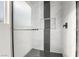 Glass shower with rain shower head and body sprayers, accented by modern black and white tile at 60 Pecos St, Las Vegas, NV 89110