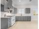 Bright, modern kitchen featuring gray cabinets, white quartz countertops, and stainless steel appliances at 60 Pecos St, Las Vegas, NV 89110