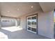 Covered patio features dual ceiling lights and sliding glass doors to inside at 60 Pecos St, Las Vegas, NV 89110
