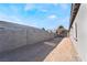 Side yard with gray block wall and access gate at 60 Pecos St, Las Vegas, NV 89110