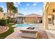 Outdoor pool features an outdoor kitchen, firepit, and gazebo at 623 Blue Snow River Ct, Henderson, NV 89002