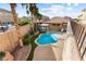 Aerial view of a backyard featuring a pool, hot tub, lush landscaping, and privacy walls at 623 Blue Snow River Ct, Henderson, NV 89002