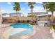 Backyard with a swimming pool, gazebo with a hot tub, privacy wall, and palm trees at 623 Blue Snow River Ct, Henderson, NV 89002