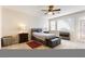 A cozy bedroom features a ceiling fan, dresser, and french doors to the outside at 623 Blue Snow River Ct, Henderson, NV 89002