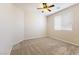Bedroom featuring carpeted floors, ceiling fan, and a large window at 623 Blue Snow River Ct, Henderson, NV 89002
