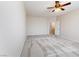 Bright bedroom featuring carpeted floors, ceiling fan, and view to ensuite at 623 Blue Snow River Ct, Henderson, NV 89002