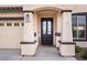 The front entry features a decorative glass door and desert landscaping at 623 Blue Snow River Ct, Henderson, NV 89002