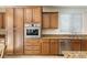 A well-lit kitchen shows granite counters, stainless steel appliances, and wood cabinets at 623 Blue Snow River Ct, Henderson, NV 89002