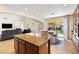 Open concept kitchen with granite island, stainless appliances, and view to the living space and backyard at 623 Blue Snow River Ct, Henderson, NV 89002