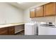 Laundry area includes sink, countertop space, cabinets, and modern washer/dryer units at 623 Blue Snow River Ct, Henderson, NV 89002