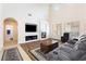Cozy living room with a fireplace, hardwood floors, and open archway access at 623 Blue Snow River Ct, Henderson, NV 89002
