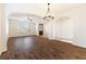 Bright living room features wood floors, chandelier, archways to other rooms, and a front door at 623 Blue Snow River Ct, Henderson, NV 89002