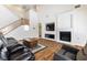 Inviting living room with a fireplace, comfortable seating, and staircase access at 623 Blue Snow River Ct, Henderson, NV 89002