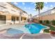 Inviting backyard featuring a sparkling pool, manicured landscaping, and covered patio at 623 Blue Snow River Ct, Henderson, NV 89002