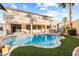 Stunning backyard showcasing a refreshing pool, lush greenery, and a relaxing outdoor space at 623 Blue Snow River Ct, Henderson, NV 89002