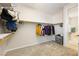 Bright walk-in closet featuring carpeted floor and custom shelving at 623 Blue Snow River Ct, Henderson, NV 89002
