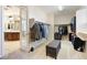 Walk-in Closet featuring carpeted floor, custom shelving, and view to main bath at 623 Blue Snow River Ct, Henderson, NV 89002