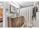 Bathroom featuring double sinks, granite countertops, and a shower/tub combo, providing both comfort and convenience at 628 Carlos Julio Ave, North Las Vegas, NV 89031