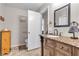 Well-lit bathroom featuring a vanity with granite countertop and decorative cabinetry, offering functionality and style at 628 Carlos Julio Ave, North Las Vegas, NV 89031