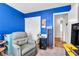 Inviting bedroom with bright blue accent wall and ample storage, creating a comfortable and organized space at 628 Carlos Julio Ave, North Las Vegas, NV 89031