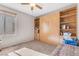 Cozy bedroom featuring built-in shelving, a comfortable bed, and natural light, offering a versatile and relaxing space at 628 Carlos Julio Ave, North Las Vegas, NV 89031