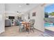 Charming dining area with a round table adjacent to a sliding glass door leading to the pool, blending indoor-outdoor living at 628 Carlos Julio Ave, North Las Vegas, NV 89031