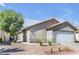 Single story home with desert landscaping, side yard access and an attached garage at 628 Carlos Julio Ave, North Las Vegas, NV 89031