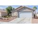 Charming single story home with desert landscaping, attached garage and tile roof at 628 Carlos Julio Ave, North Las Vegas, NV 89031