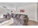 Bright living room featuring plush seating, ceiling fan, and modern flooring at 628 Carlos Julio Ave, North Las Vegas, NV 89031