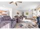 Spacious living room with wood look floors and comfortable seating under a ceiling fan at 628 Carlos Julio Ave, North Las Vegas, NV 89031