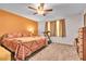 Comfortable main bedroom featuring a ceiling fan, neutral carpet, and a warm, inviting color palette at 628 Carlos Julio Ave, North Las Vegas, NV 89031