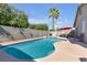 Beautiful backyard pool and spa with a tall palm tree and a red umbrella, perfect for relaxing at 628 Carlos Julio Ave, North Las Vegas, NV 89031