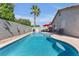 Sparkling pool and spa area with lush landscaping and a privacy fence, perfect for outdoor relaxation and entertainment at 628 Carlos Julio Ave, North Las Vegas, NV 89031