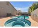 Backyard pool and jacuzzi with nice pavers and hardscape under a sunny blue sky at 628 Carlos Julio Ave, North Las Vegas, NV 89031