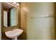 Half bathroom featuring a pedestal sink, mirror, and neutral wall color at 6540 Angel Mountain Ave, Las Vegas, NV 89130