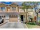 Charming two-story townhome with attached garage, desert landscaping, and a welcoming front entrance at 6540 Angel Mountain Ave, Las Vegas, NV 89130