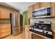 Updated kitchen with stainless steel appliances, granite countertops, and light wood cabinetry at 6540 Angel Mountain Ave, Las Vegas, NV 89130