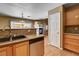 Updated kitchen showing granite counters, stainless steel appliances, and view into the living room at 6540 Angel Mountain Ave, Las Vegas, NV 89130
