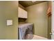 A conveniently located laundry room features a modern washer and dryer at 6540 Angel Mountain Ave, Las Vegas, NV 89130