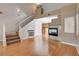 Comfortable living space with a fireplace, staircase, and views into the kitchen at 6540 Angel Mountain Ave, Las Vegas, NV 89130