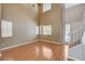 Bright and open living area with hardwood floors, high ceilings, and a staircase at 6540 Angel Mountain Ave, Las Vegas, NV 89130