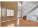Inviting living room featuring hardwood floors, staircase, and a front entrance with plenty of light at 6540 Angel Mountain Ave, Las Vegas, NV 89130