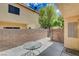 Cozy outdoor patio area enclosed by a brick wall, perfect for relaxing or entertaining guests at 6540 Angel Mountain Ave, Las Vegas, NV 89130