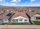 Aerial view of a well-maintained backyard, including a patio, artificial grass and hot tub at 6557 Corsari Ridge St, Las Vegas, NV 89166
